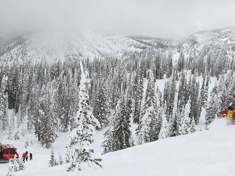 Skier and Snowcat Steamboat Powdercats