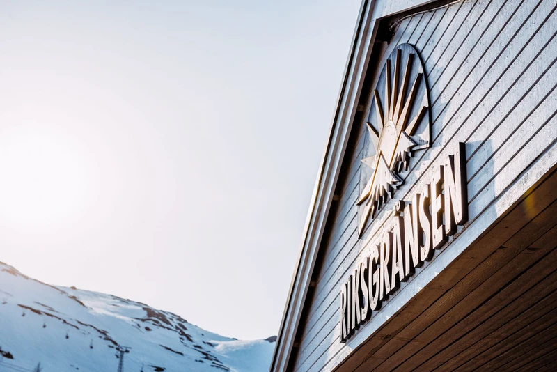 5fa90db573400 Riksgransen Hotel Sign and Mountains