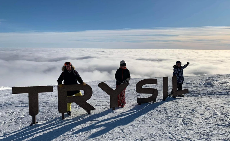 Family posing top of Trysil, Norway - Trudy Wilkes Thompson - February 2023