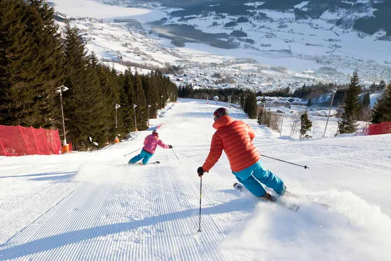 667c219fe54bd Voss Resort Two skiers on wide groomed slope N Ho S Morgenkjoring