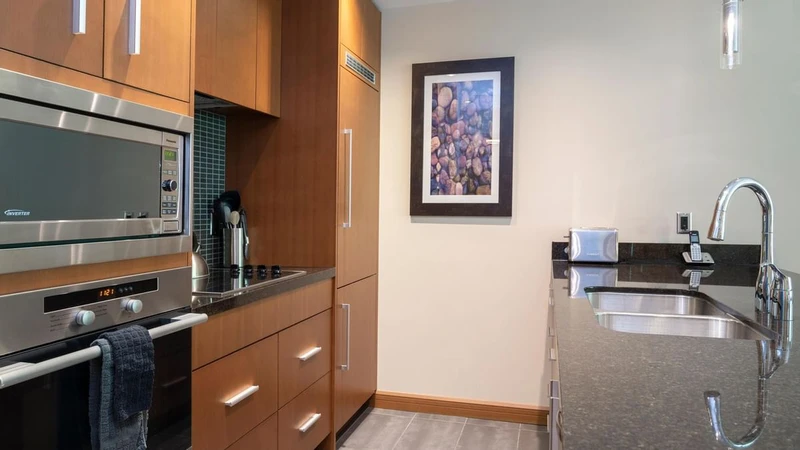 66c752df3d292 Sutton Place Hotel One Bedroom Suite Kitchen