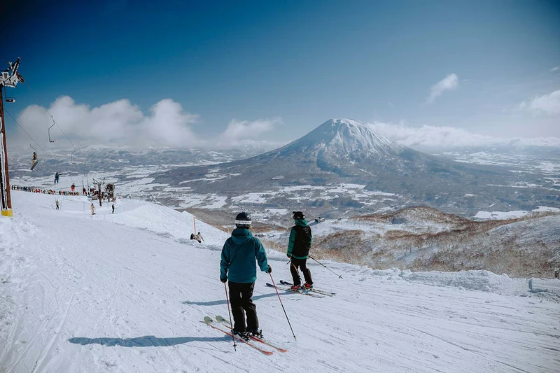 6706aa83f02f2 Two skiers and Mt Yotei Niseko Japan Pete Elliot