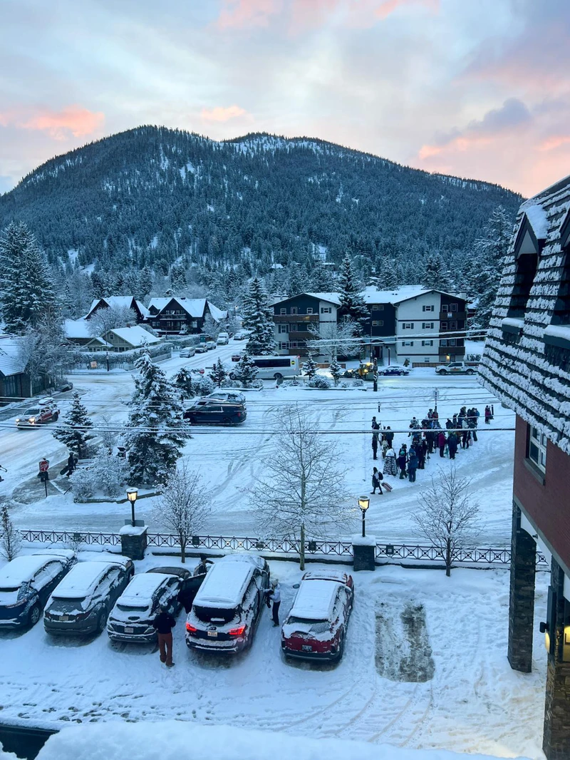 6734dd386a1c4 Skiers queuing up for the shuttle buses outside the Mount Royal in Banff