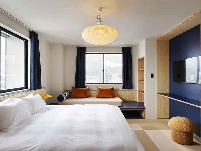 67b497aed7344 EVO Hotel Hakuba Deluxe Room Day Bed Hakuba Hospitality Group