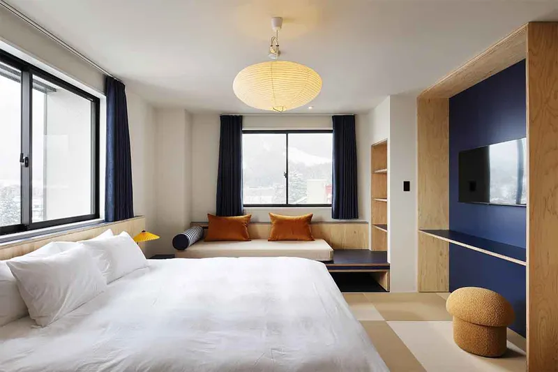 67b497aed7344 EVO Hotel Hakuba Deluxe Room Day Bed Hakuba Hospitality Group