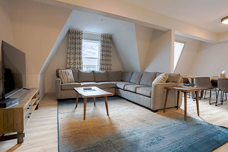 67f5366005823 Basecamp Banff Suites Superior Three Bedroom Apartment Living Area CARD