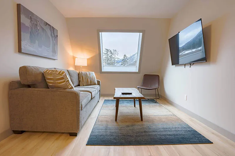 67f545473a912 Basecamp Banff Suites Superior King Two Bedroom Apartment Living Area