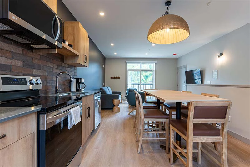 67fa5d69c4448 Basecamp Suites Revelstoke Four to Six Bedroom Suites Kitchen Living