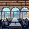 Spring View Dining Area at Fleischer's Hotel with a panoramic lake view through arched windows