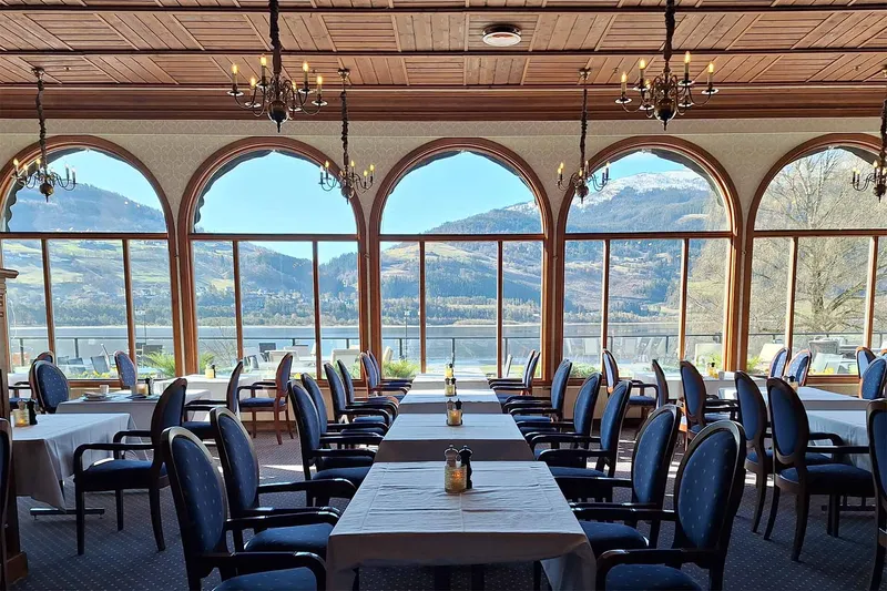 Spring View Dining Area at Fleischer's Hotel with a panoramic lake view through arched windows