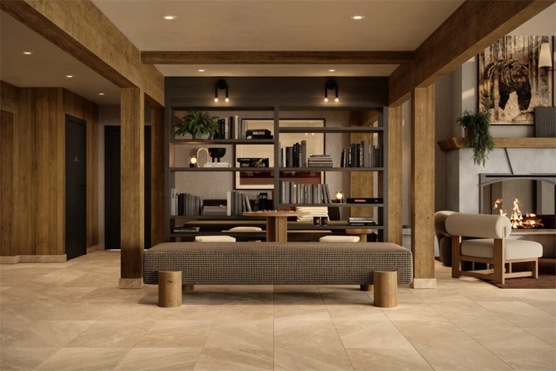 Arrowood Living Room with bookcase, sofas and a fireplace at The Kenrick Hotel