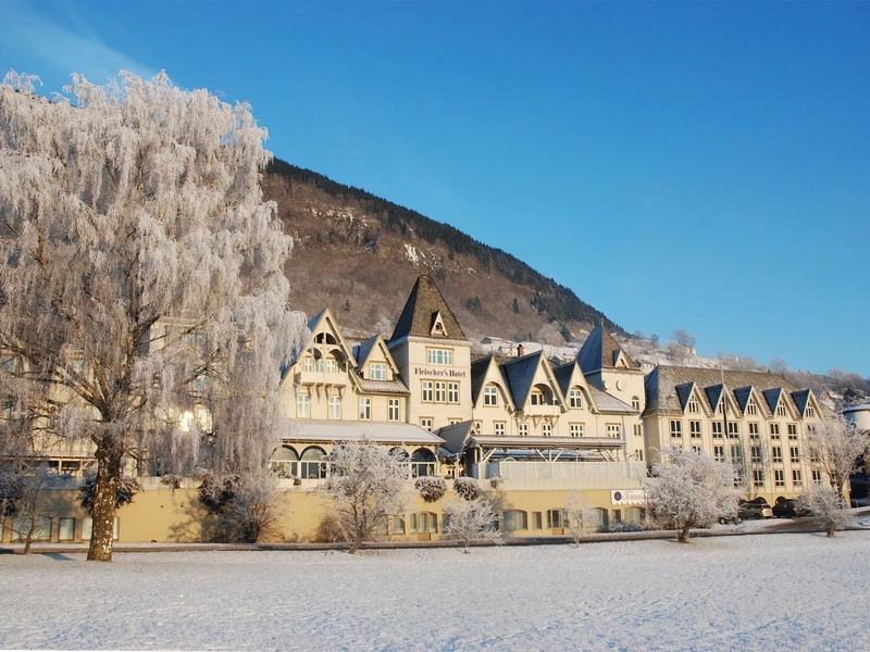 Street view of Fleischer's Hotel on a snowy, sunny day