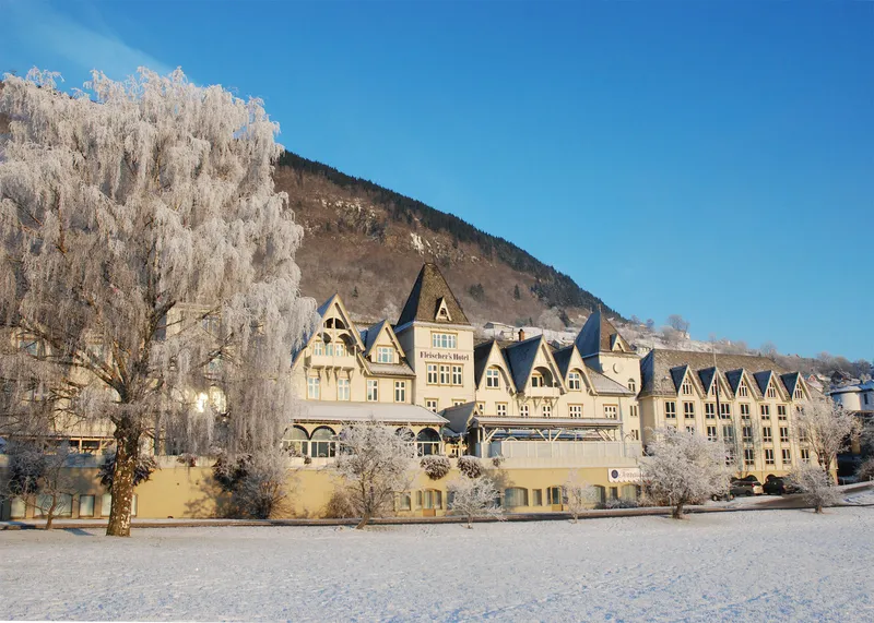 Street view of Fleischer's Hotel on a snowy, sunny day