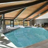 Large indoor pool with sun loungers