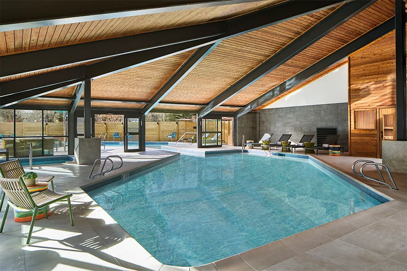 Large indoor pool with sun loungers