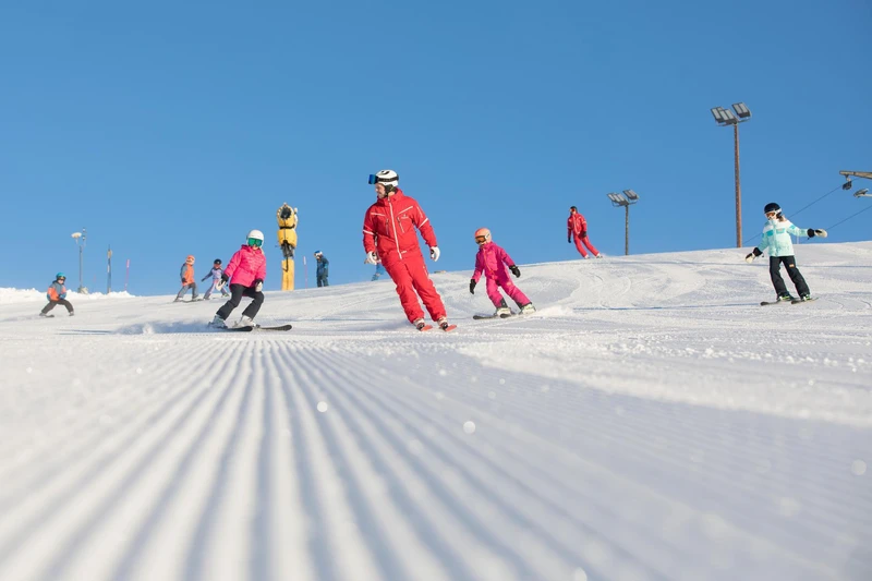 Group of children learning in ski school in Norefjell, Norway on a sunny day