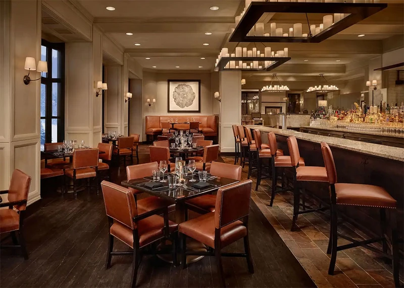 Tables and benches at the bar of the Brass Bear at Park Hyatt Resort & Spa