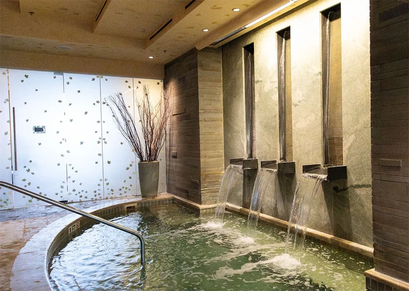 Small hot pool with waterfalls and low lighting