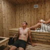 A couple enjoying the sauna at the Kendrick Hotel