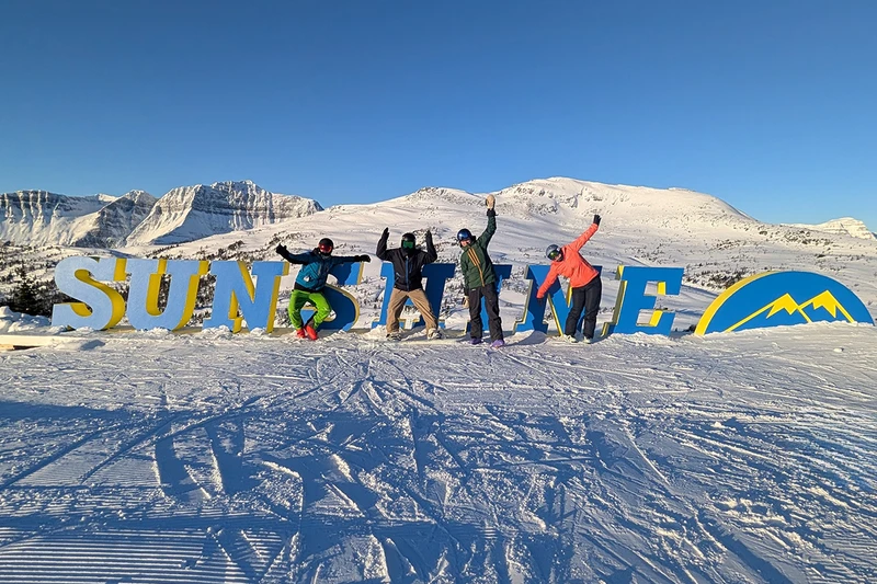 Standing by the Banff Sunshine Village sign
