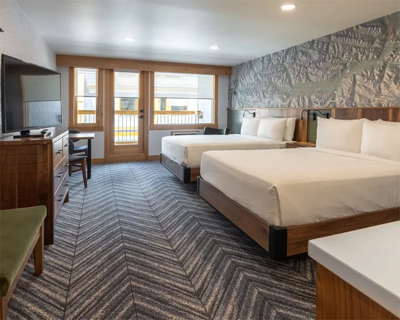 Two queen size beds in a hotel room