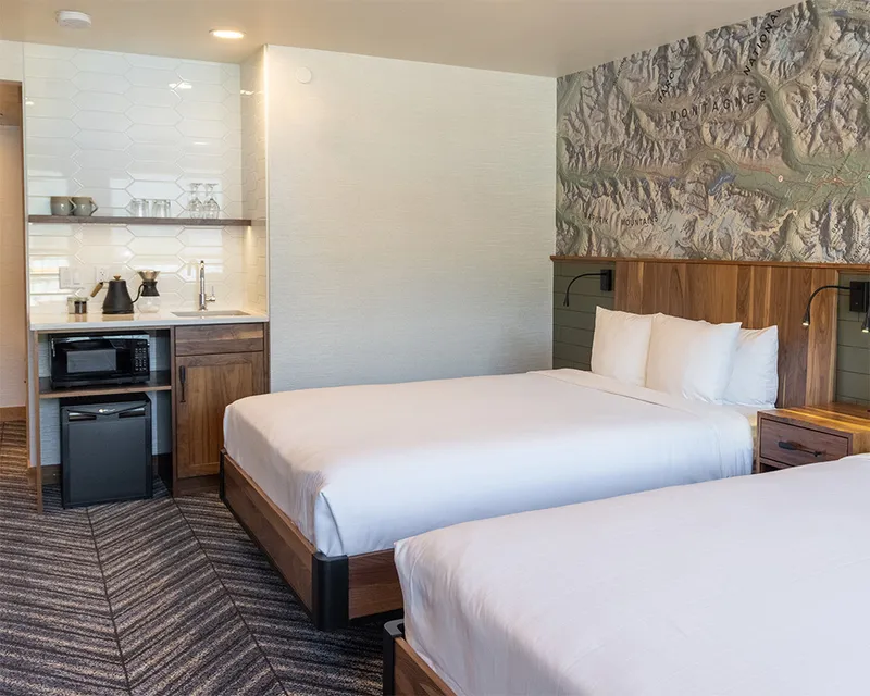 Hotel room with two queen beds, mini fridge and sink