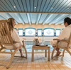 Couple relaxing in deckchairs beside the pool inside Fleischer's Hotel