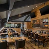 Spacious restaurant with wooden floors and wall panels at Hotel Thaynes