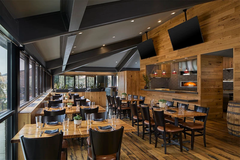 Spacious restaurant with wooden floors and wall panels at Hotel Thaynes